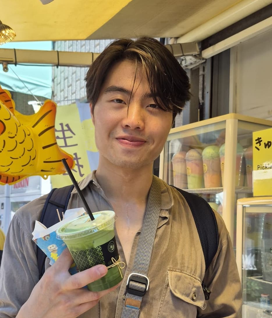 Zach smiling in a café